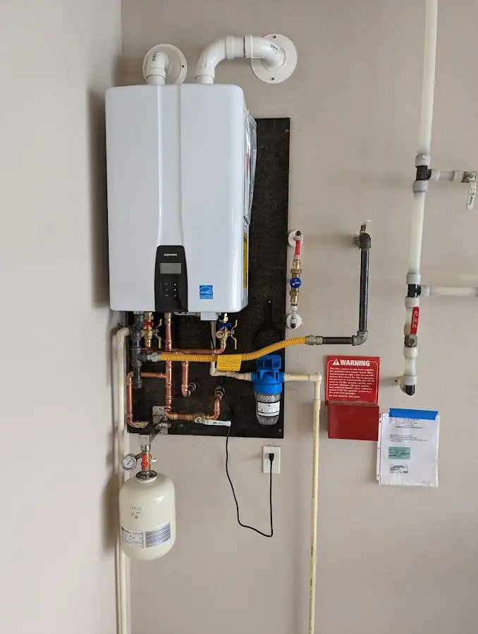 Professional plumber installing copper piping in a Alliance home